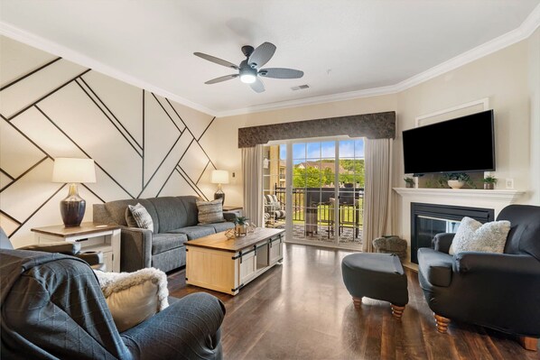 Cozy and spacious living area with TV and fireplace