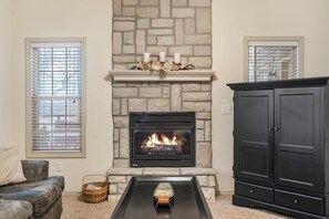 Modern spacious living area with TV and fireplace