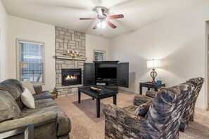 Modern spacious living area with TV and fireplace