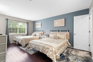 This chic suite offers a pair of plush queen beds, private ensuite & smart TV