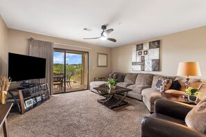 Floor-to-ceiling sliding glass doors in the living area