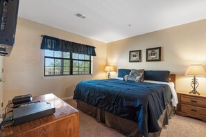 Bedroom 1 with King bed, TV and private en-suite