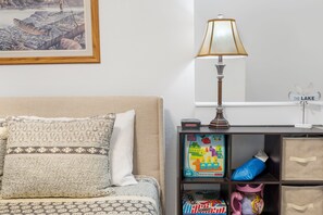 The loft bedroom features a queen bed, sitting area with games, & ensuite