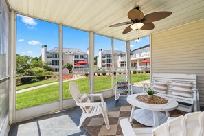 Enjoy dining & lounging with a view on the screened-in patio