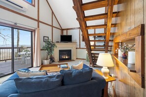 Cozy and spacious living area with TV and fireplace