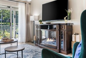 Cozy and spacious living area with TV and fireplace
