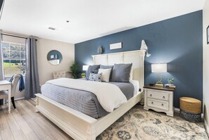 Bedroom with King bed, desk, and TV