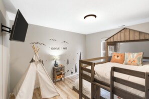 Kids will adore this camp-style bedroom with twin-over-full bunk beds & Smart TV