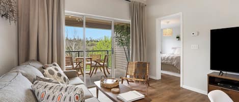 Modern spacious living area with TV