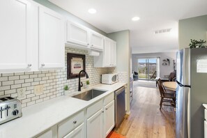 This airy kitchen offers ample space & all the comforts of home