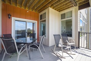 Large covered deck with lakeview and outdoor furniture