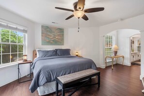 The primary king suite boasts a private ensuite, Smart TV, & balcony access