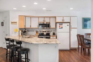 The airy kitchen offers ample space & all the comforts of home