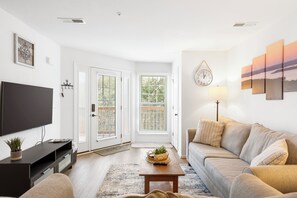 Open living space with comfy seating and, Smart TV