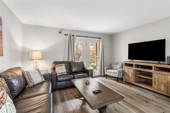 Modern spacious living area with TV
