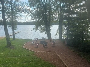 Fire pit with firewood by the water