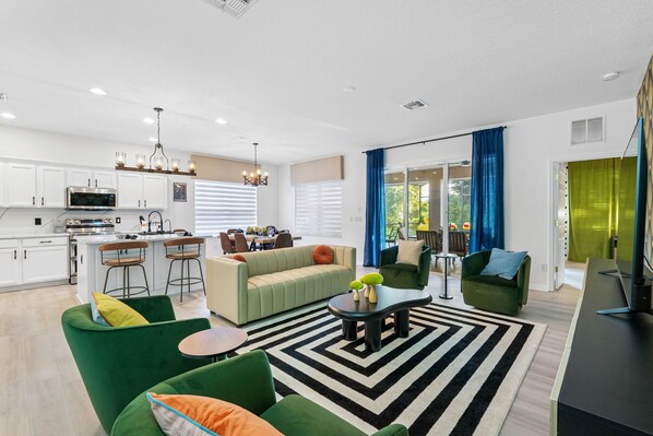 The living room is in an open floor plan concept with the dining area & kitchen