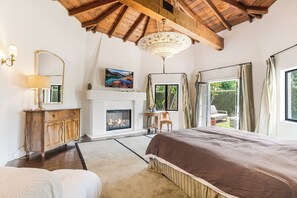 Primary bedroom with fireplace, outdoor terrace & seating, large walk-in closet