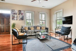 Plush seating, contemporary decor with striking patterns, a smart TV & workspace