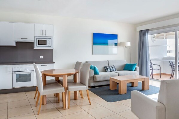 Bright and airy living room with comfortable seating, merging effortlessly into the dining area for an open-concept feel.
