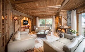 Relax in the comfy living area and warm-up by the fireplace after a day outside.