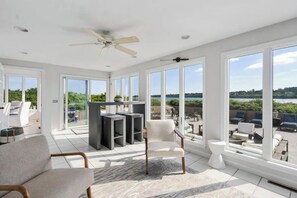 sun filled sun room for lounging and watching the tide