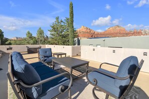 Upper patio offers comfortable seating and scenic views