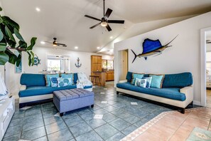 The cozy living room with two spacious sofas, offers plenty of seating for guests to relax and enjoy the inviting, open atmosphere.