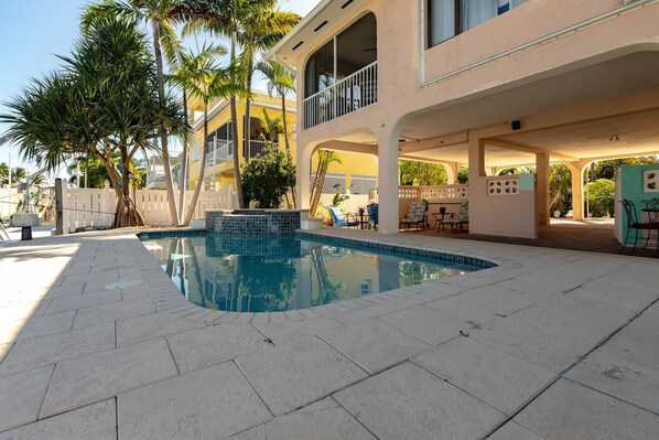 The pool and expansive pool deck offer a perfect outdoor retreat, with plenty of space for lounging and swimming,