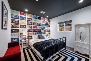 Primary Bedroom features a queen bed and TV.