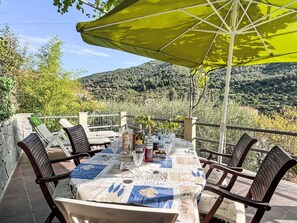 Furniture, Plant, Table, Property, Chair, Tableware, Outdoor Table, Shade, Outdoor Furniture, Sky