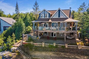 The Lion's Den Cottage, perched right on the edge of Georgian Bay, with panoramic views and direct access to the water. The perfect retreat for a peaceful getaway.