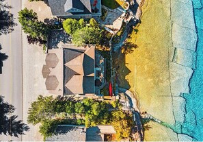 Escape to luxury on the crystal-clear shores of Isthmus Bay. This aerial view of the Lion's Den property captures the spacious layout and direct waterfront access, just minutes from Lion’s Head.