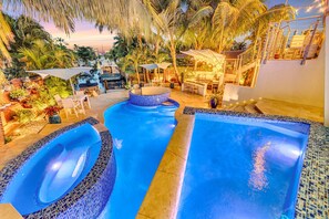 The heated pool and lounge area cascade into one another, creating a tranquil waterfront oasis with canal views.
