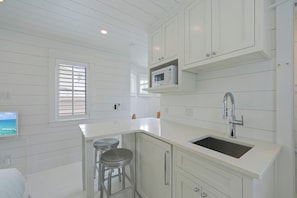 KITCHENETTE AND BAR SEATING FOR TWO ON SECOND STORY