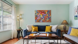 Beautiful living room with comfortable sofas, natural light, and smart tv