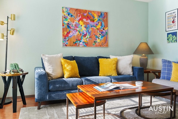 Beautiful living room with comfortable sofas, natural light, and smart tv