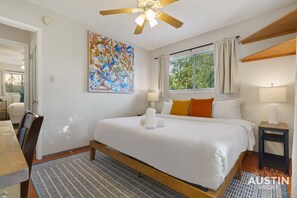 King bedroom with luxury linens, work desk/ vanity, and closet
