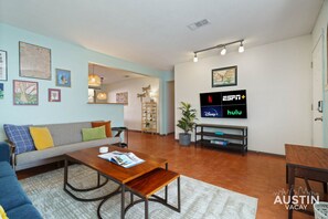 Beautiful living room with comfortable sofas, natural light, and smart tv