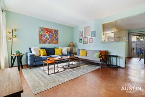 Beautiful living room with comfortable sofas, natural light, and smart tv
