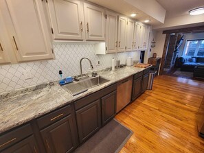 Looking from the kitchen into the den, there is one step from when you enter the den to the kitchen and the rest of the main floor.