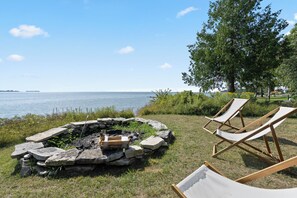 Firepit leads to dock down grassy steep path