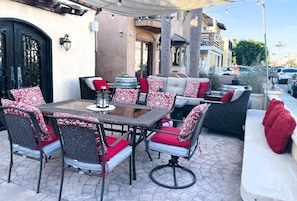 The large front patio features welcoming indoor/outdoor flow and cozy seating.