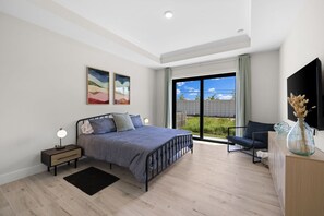 A king bed, large sliding glass doors to let the light in, and soft linens.