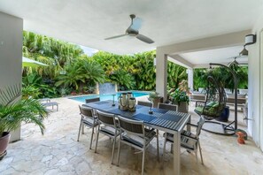 The patio is large and runs the length of the Villa - one side leading off the living spaces,
and the other to the swimming pool
The patio has a large, outdoor BBQ-Grille
Feature: Cushioned “swing chair” 