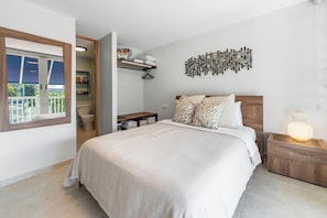 Master Bedroom: En-suite – top floor: Queen Bed; Closet; Wall-to-wall slatted blinds/shades; Full bathroom; 45” flat-screen TV atop a wooden sideboard; Split-unit A-C;
