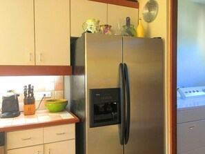 Fully equipped kitchen
2-stool bar seating
Dishwasher
Double-door refrigerator with ice-maker
Flush-top induction stove on center, tiled island
Blender, Coffeemaker, and Toaster Oven
Microwave Oven
White flush cabinetry
