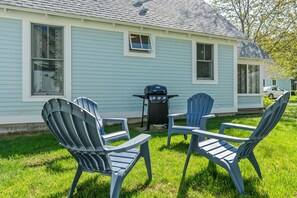 Outdoor seating with gas grill.