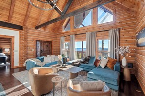 Gather together in the great room with wall of windows with mountain views.