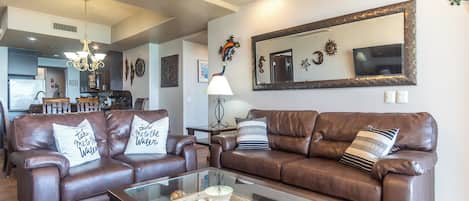 Two classic leather sofas dominate the living room, promising comfort.